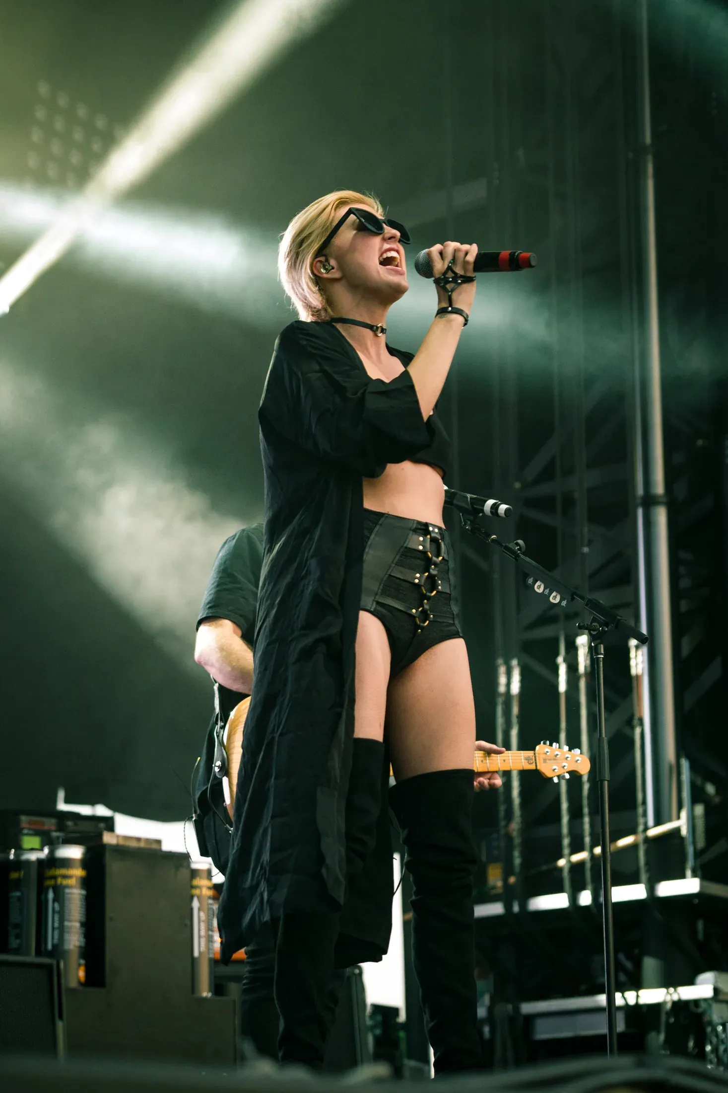 A singer performing on an outdoor stage.