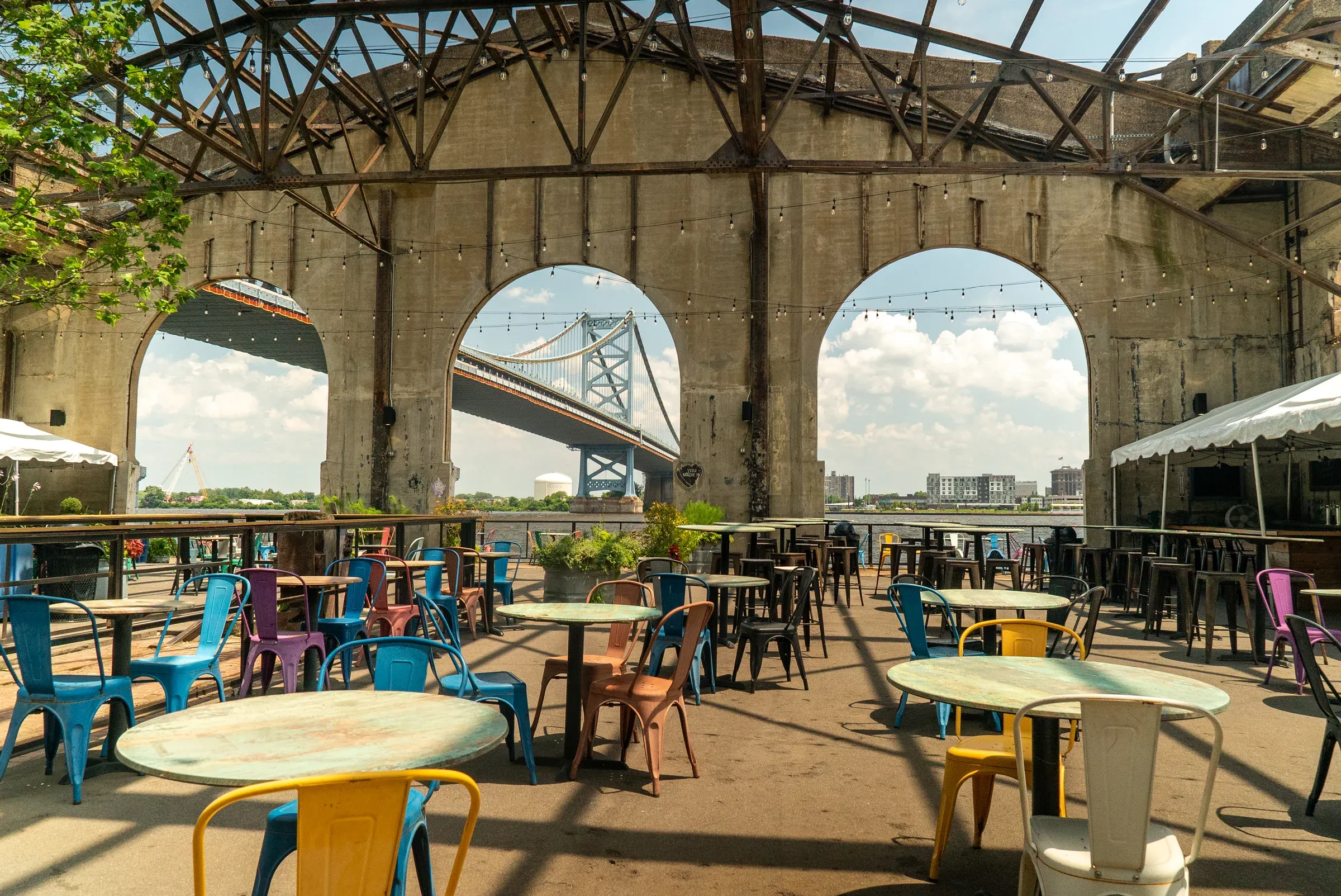 Guests gathering on a colorful waterfront patio in Philadelphia.