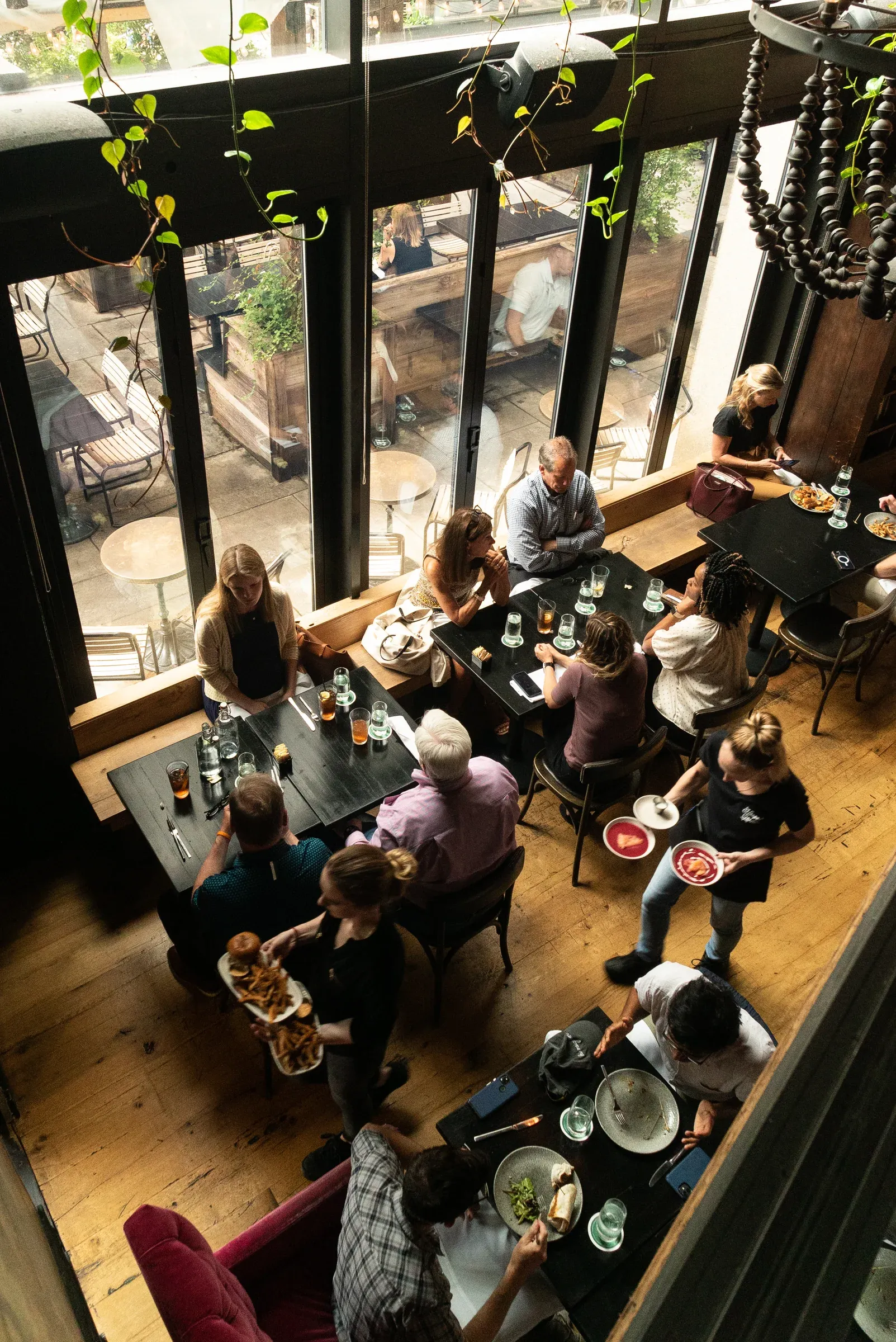 A busy restaurant dining room photographed from above.