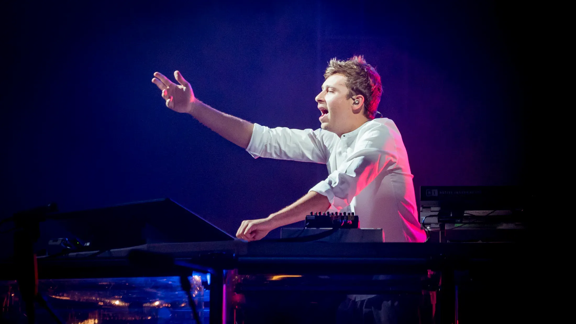 A keyboardist reaching toward the audience.