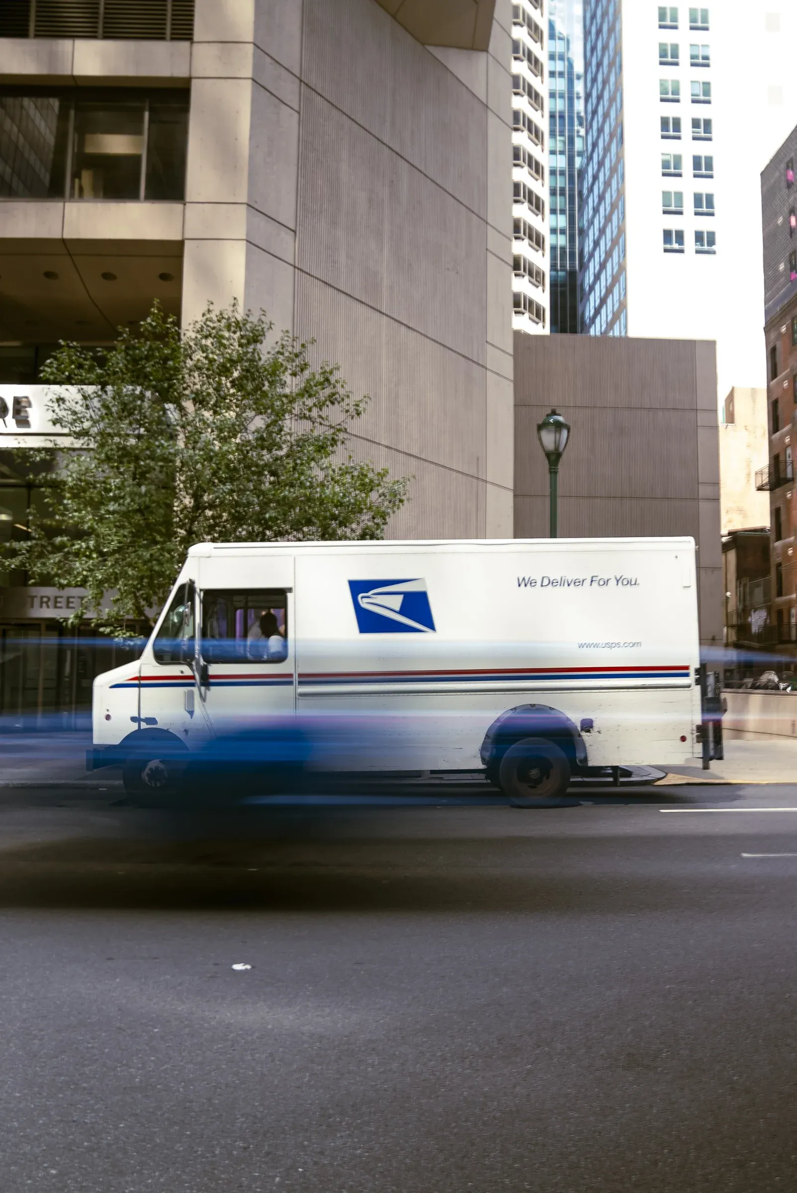 A blue USPS scene photographed with motion blur.