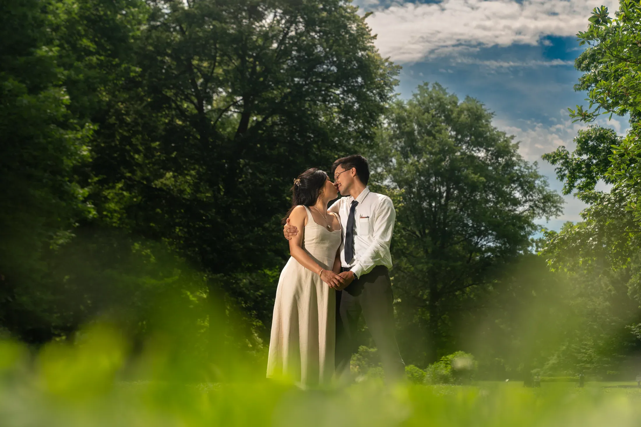 A couple sharing a candid portrait outdoors.