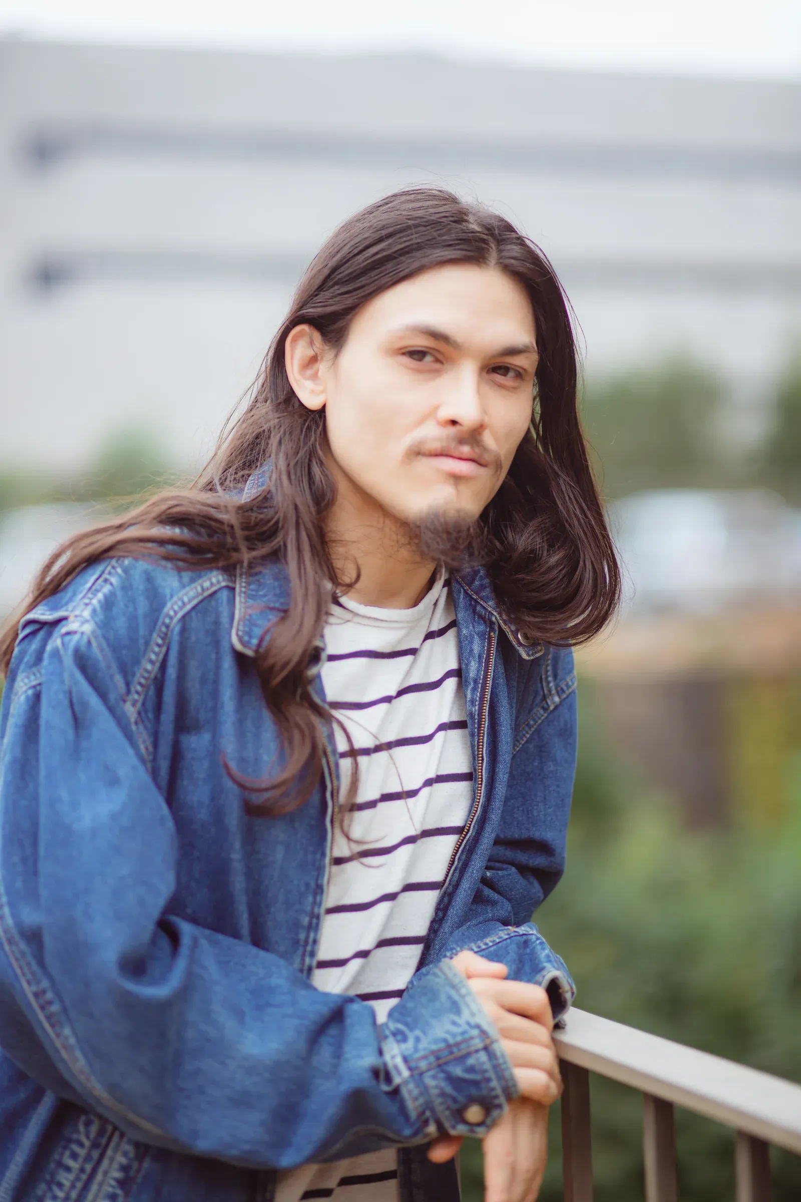 Portrait of Joshua Hoang in a denim jacket.